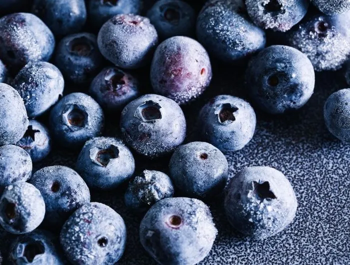 Frozen blueberries closeup with frost texture