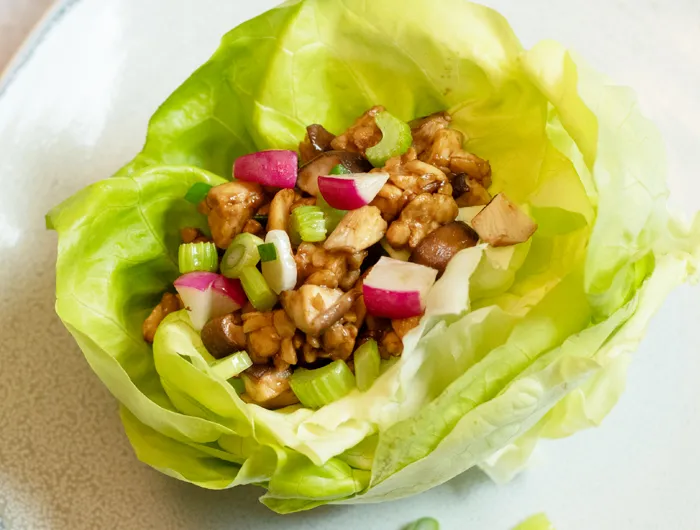 lettuce cup filled with various vegetables and tempeh