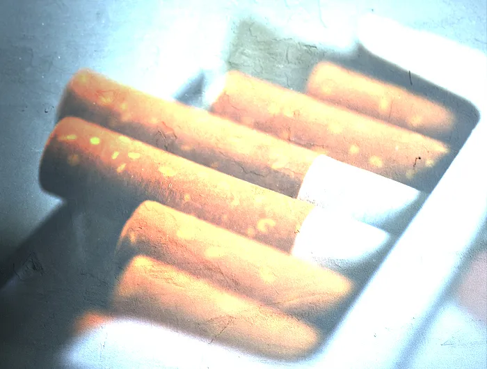 open pack of cigarettes with filter over it