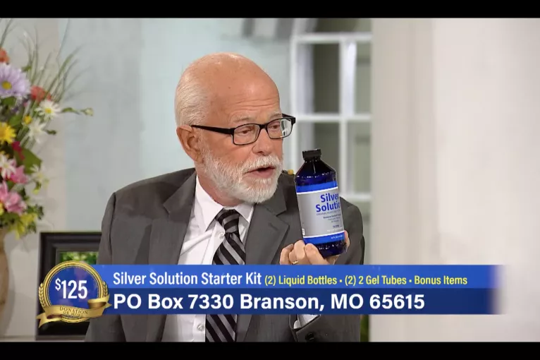 Jim Bakker holding silver solution on his TV show