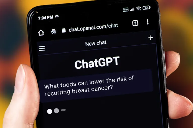 hand holding smart phone that says "ChatGPT" on screen
