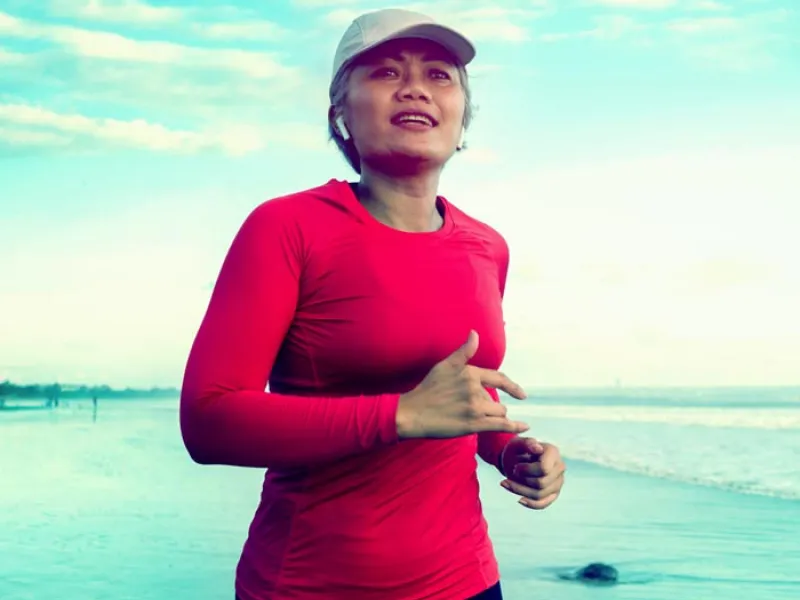 a woman jogging on the beach