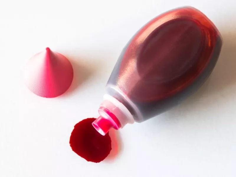 Red dye spilled onto a white surface