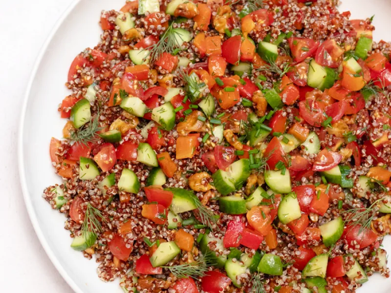 bowl of quinoa, with other chopped vegetables and herbs