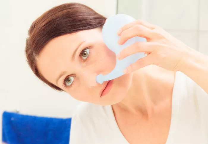 woman using a Neti pot