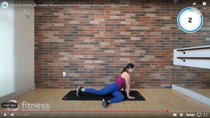 screenshot of Youtube video of woman stretching on a yoga mat