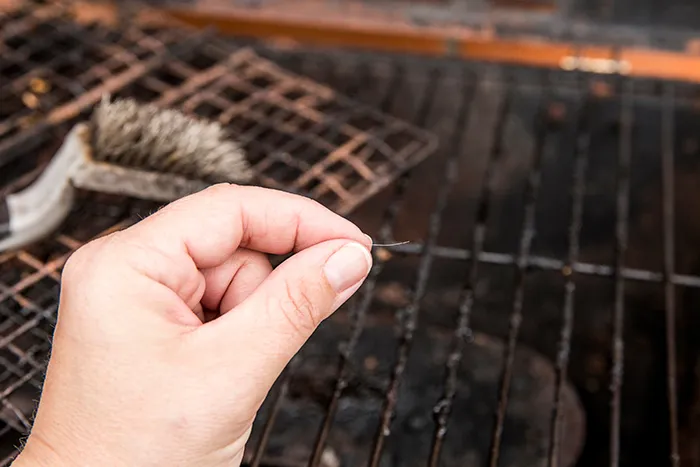 hand holding a grill brush bristle 