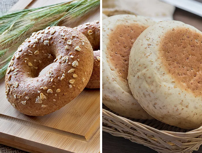 whole grain bagel on cutting board (left) and basket of english muffins (right) 