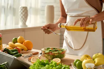 a woman pouring olive oil