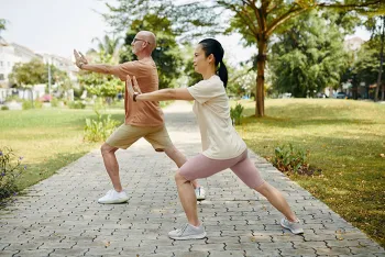 2 people doing tai chi in a park