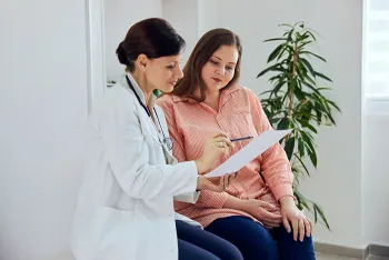 doctor explaining something on paper to patient