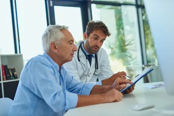 doctor speaking to older male patient