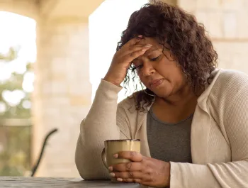 woman looking sad  and holding her head