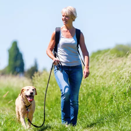 a woman walking her dog