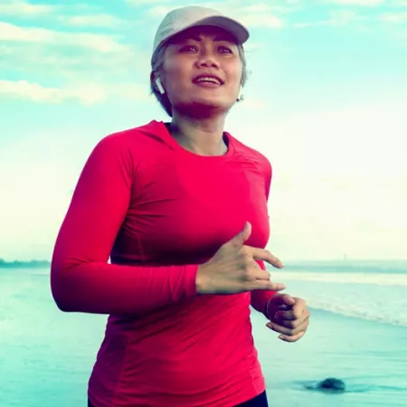 a woman jogging on the beach