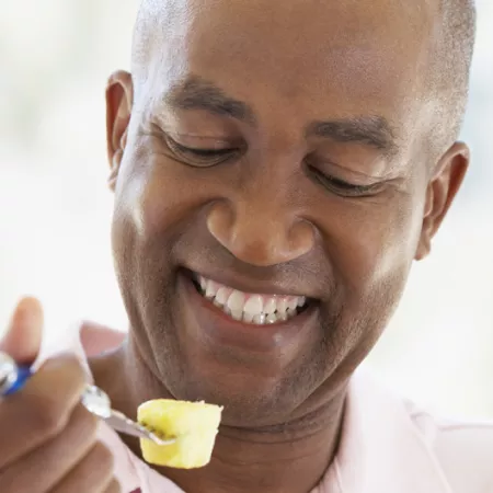 man eating pineapple
