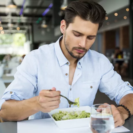man eating pasta