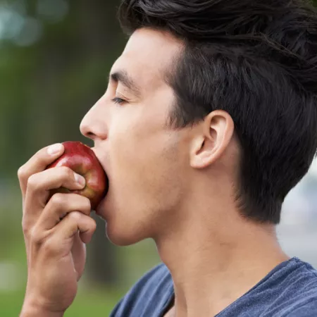 person biting an apple