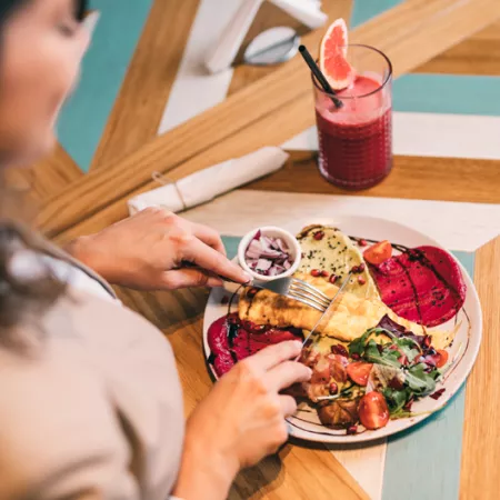 woman eating off full plate of food