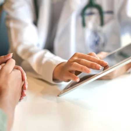 doctor and patient looking at a tablet