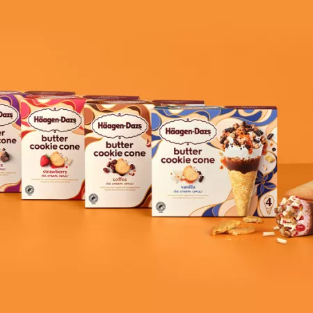 boxes of all 4 flavors of cookie cones on an orange background