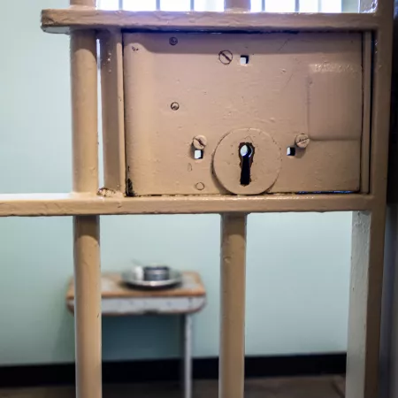 Prison cell with an empty plate and bowl on a table