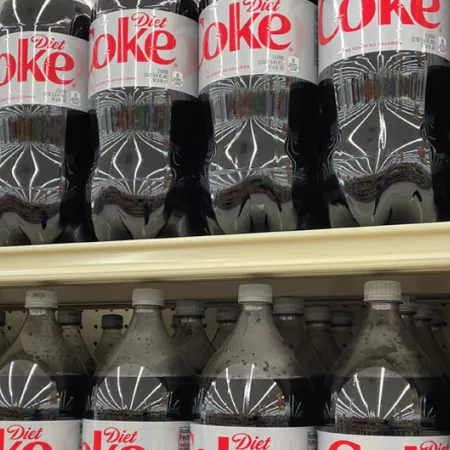 gricery store selves filled with 2 liter bottles of diet coke