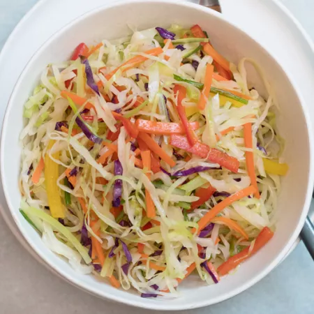 bowl filled with moo shu vegetables and chop sticks