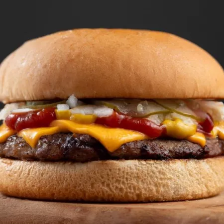 Classic burger with cheese, onions, pickle, mustard, and ketchup