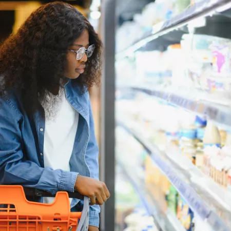 Person looking at yogurt on store 