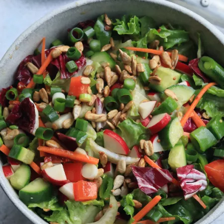 large bowl of salad with chopped lettuce and other vegetables