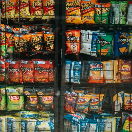 Shelves of assorted chips behind glass.