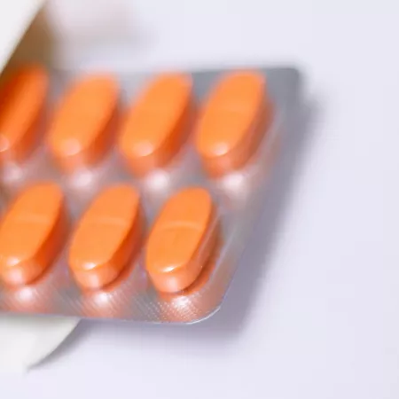 A blister pack of red oblong pills