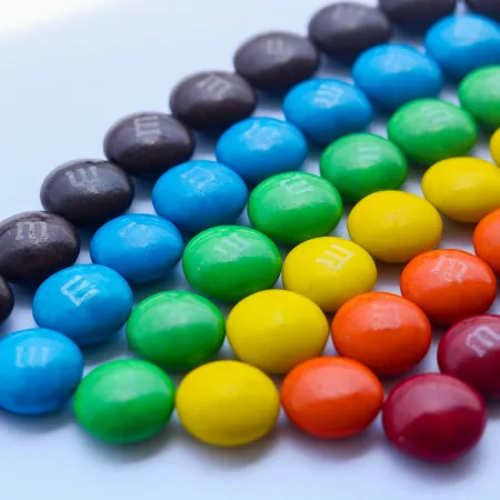 M&Ms candy arranged by color to resemble a rainbow