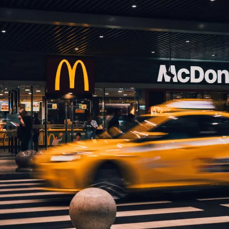 A New York City cab passing a McDonald's at night
