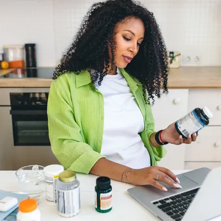 A woman researching supplements on her laptop
