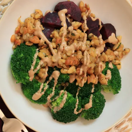 bowl of crispy tempeh, broccoli and purple sweet potato