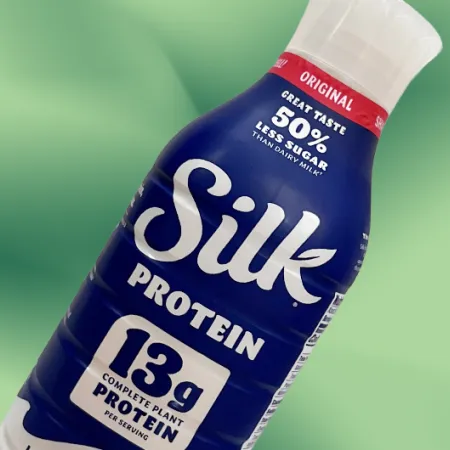 Silk protein milk on green background