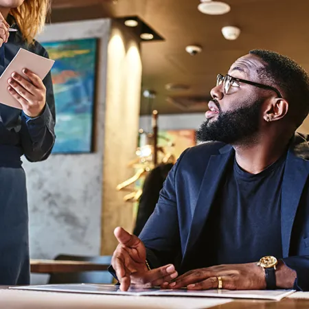 Person reading menu at a restaurant