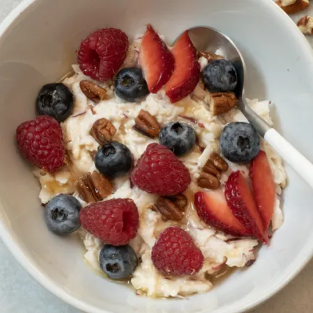 white bowl with berries and overnight oats