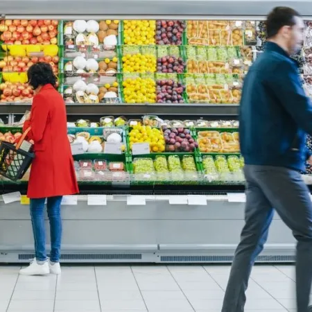 At the Supermarket: Woman Chooses Organic Fruits in the Fresh Produce Section of the Store