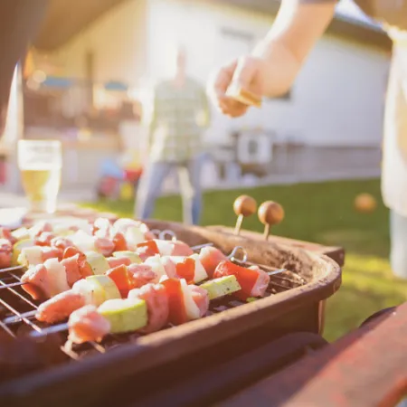person grilling in evening sunlight