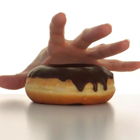 Handing reaching for a donut